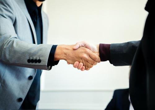 Businessmen shaking hands at the office - 1208688