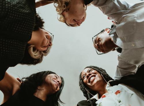 Happy diverse businesswomen huddling in the office - 1211508