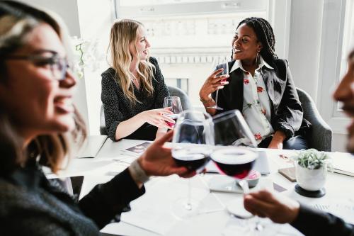 Diverse businesswomen drinking wine in the meeting room - 1211577