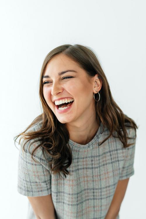 Smiling woman in a gray plaid dress - 1212532