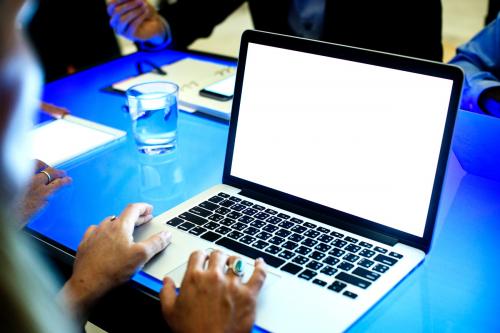 Hands on a laptop working in a meeting - 59578