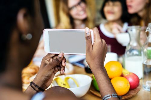 Closeup of mobile phone taking photo of diverse women - 13373