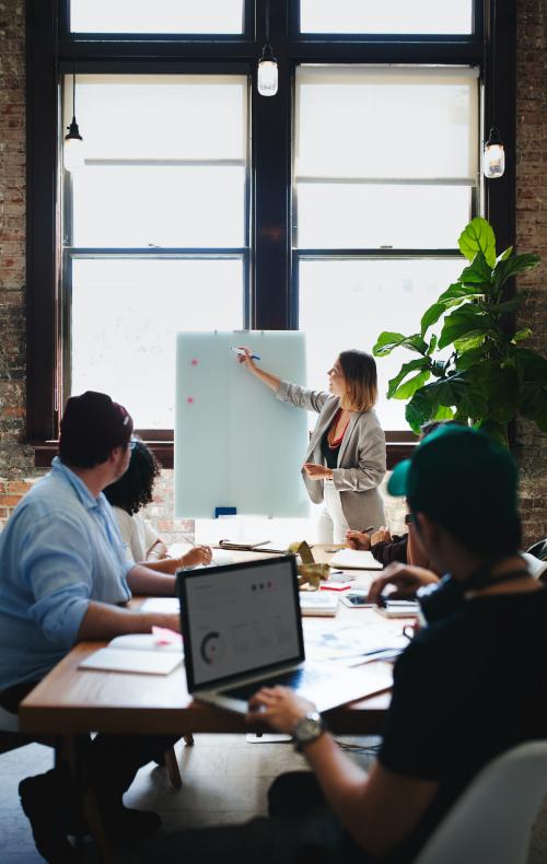 Businesswoman writing on a board in the meeting room - 1213752