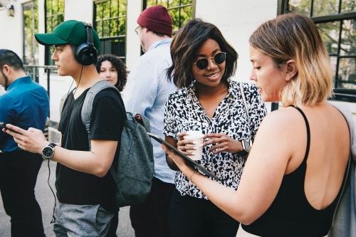 Happy women discussing at a workshop using a digital tablet - 1213770