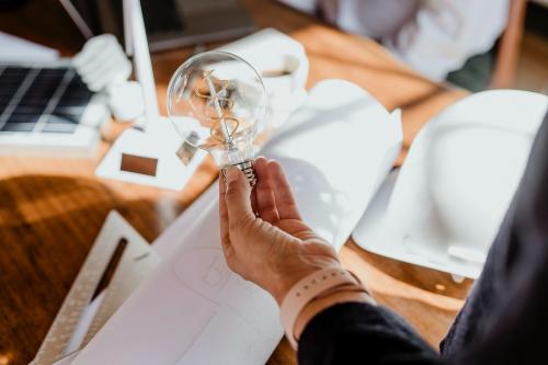 Creative man holding a light bulb - 1213925