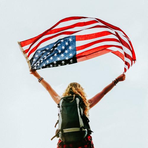 Caucasian woman holding American flag - 1214246