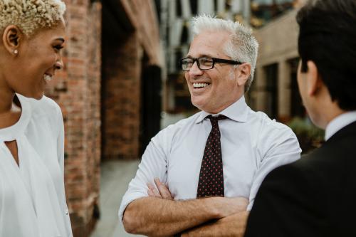 Cheerful businesspeople having a conversation - 1199589