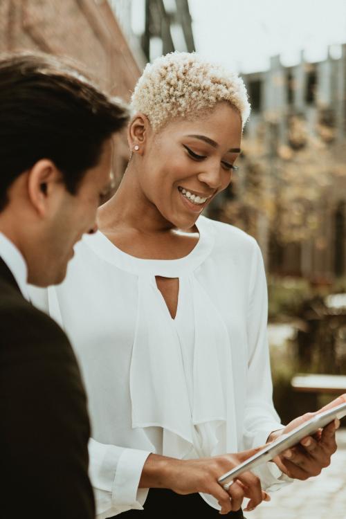 Businesspeople using a tablet in the city - 1199678