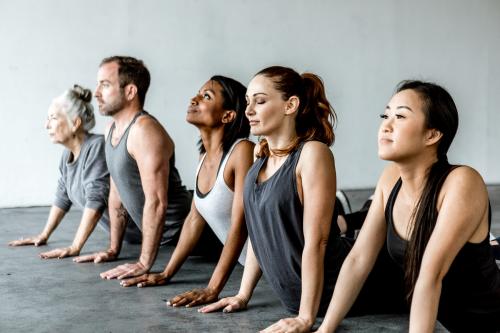 Diverse people in a Bhujangasana pose - 1201723