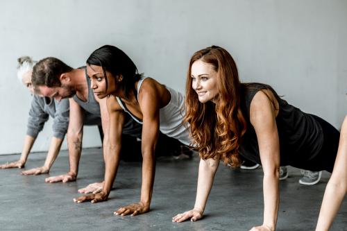 Diverse people practicing a Phalakasana pose - 1201728