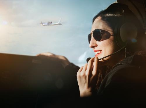 Aviator with headphones listening to the air traffic - 1202199