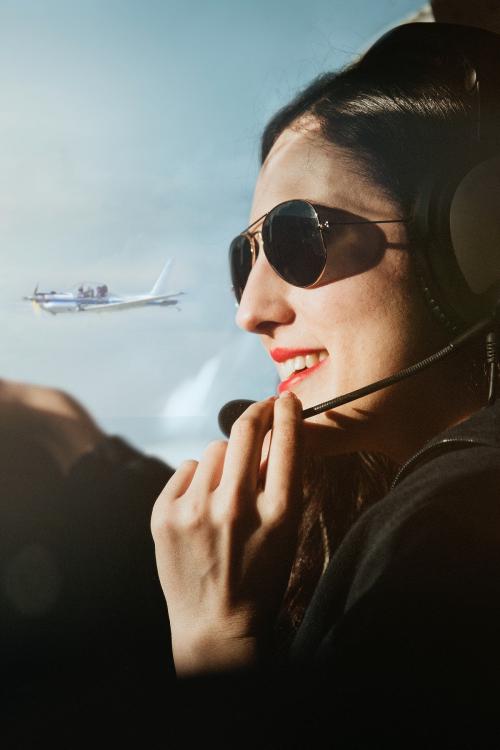 Aviator with headphones listening to the air traffic - 1202284