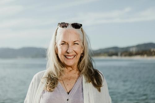 Happy senior woman by the sea - 1202653