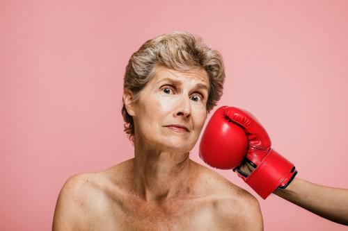 Senior woman getting punched in the face - 1203179