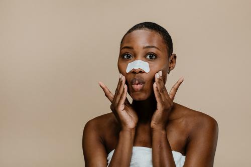 Black woman with a nose pore strip - 1203323