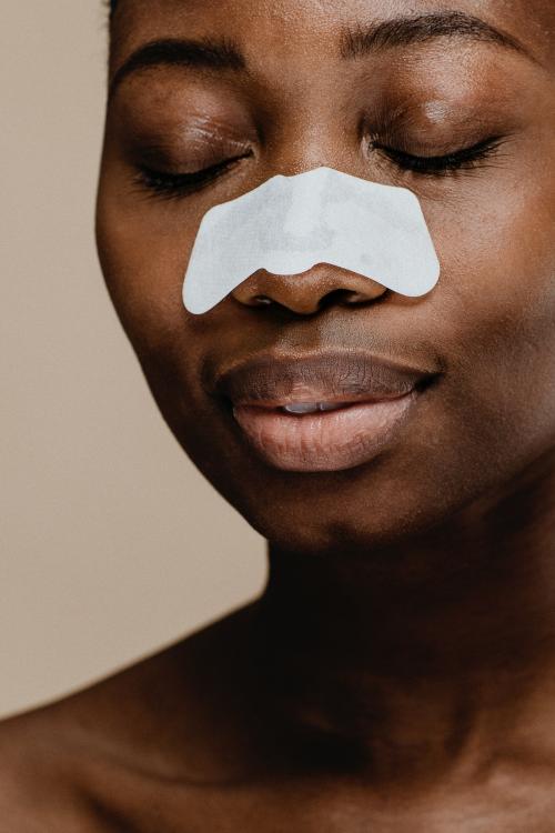 Black woman with a nose pore strip - 1203339