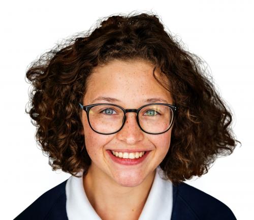 Portrait studio shoot of schoolgirl in uniform with smiling - 7630