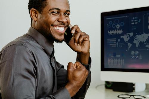 Happy black businessman talking on the phone - 1204975