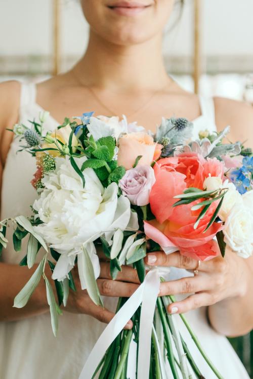 Woman carrying a beautiful flower bouquet - 1207597