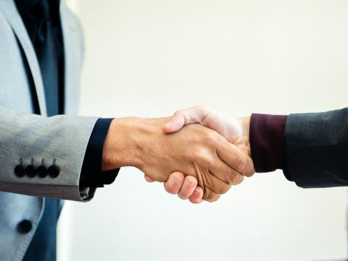 Businessmen shaking hands at the office - 1208670