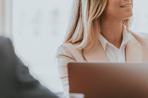 Successful woman in a meeting using a laptop - 1208674