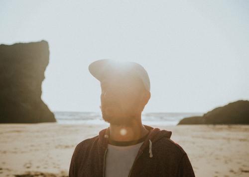 Guy walking on a sunny beach - 1215591