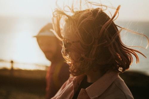 Woman strolling around with her friend in harsh winds - 1215598