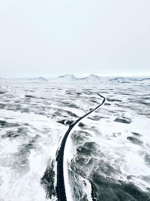 Curvy snow covered road in Northern Iceland - 1017156