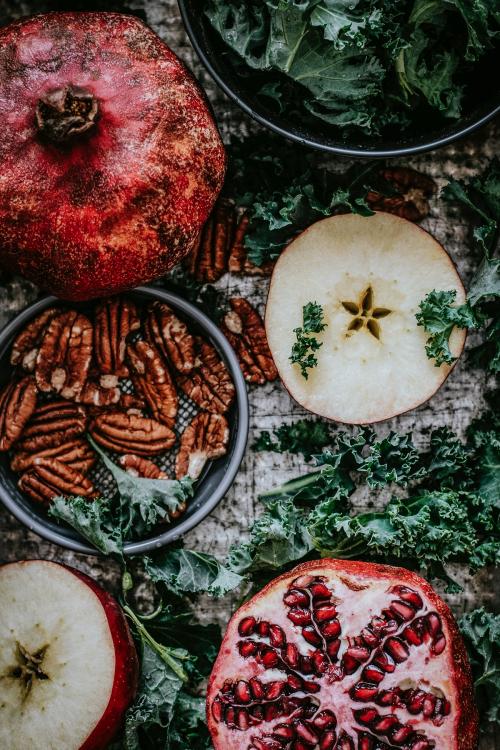 Fresh pomegranate with apples and pecans food photography - 1054333