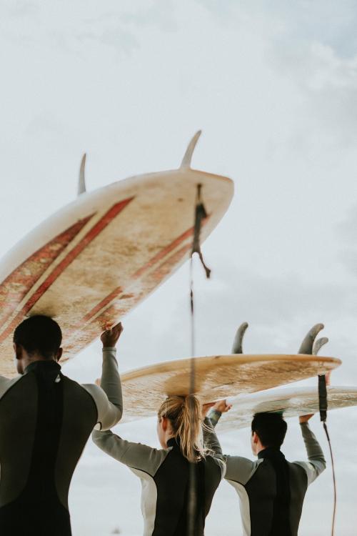 Happy friends surfing at the beach - 1079773