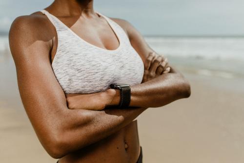 Black woman with arms crossed at the beach - 1079785