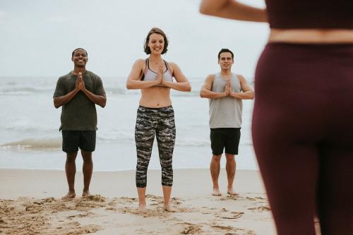 Yogis enjoying a session at the beach - 1079831