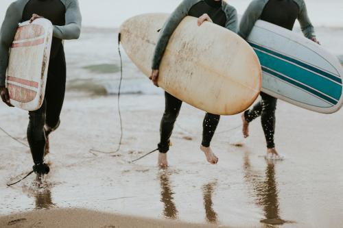 Happy friends surfing at the beach - 1079846