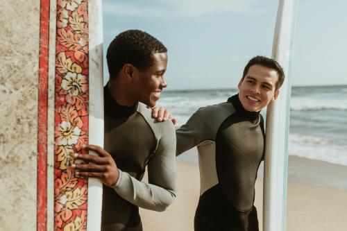 Happy surfers at the beach - 1079848