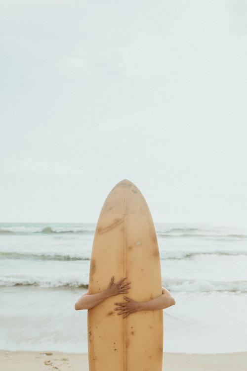 Surfer hugging a surfboard mockup - 1079857