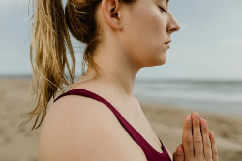 Woman practicing yoga on the beach - 1079864