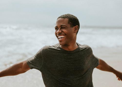 Cheerful man enjoying on the beach - 1079912