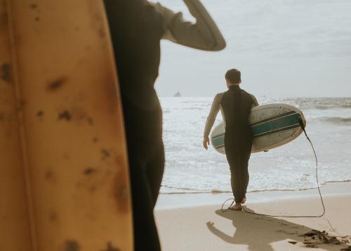 Surfers at the beach on a sunny day - 1079939