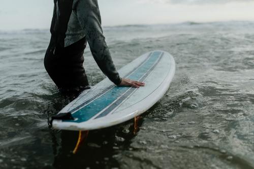 Man at the beach with his surfboard - 1080014