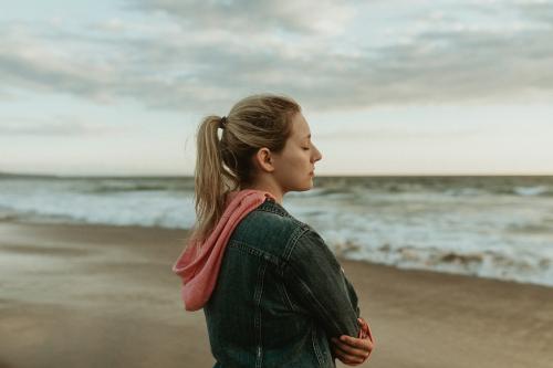 Woman on a gloomy beach - 1080017