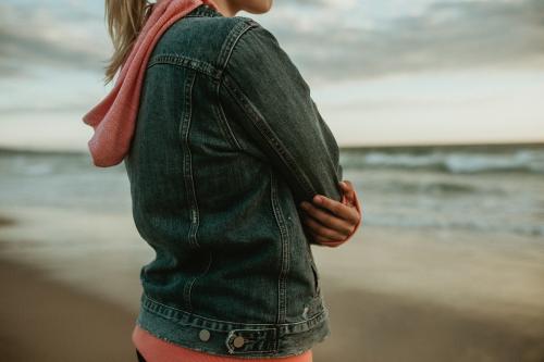 Woman on a gloomy beach - 1080019