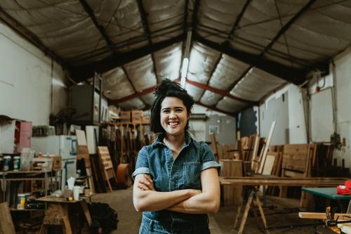 Female carpenter in her wood shop - 1199259