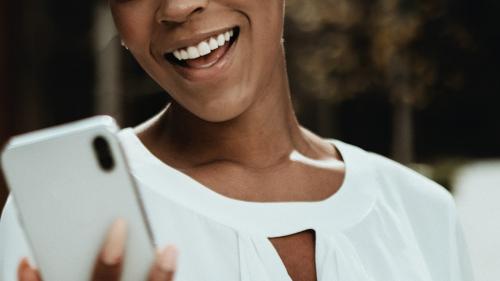 Happy black woman on her phone - 1199614