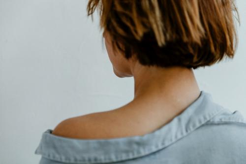 Rear view of a short dyed hair in a denim shirt - 1200483