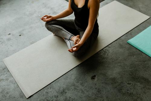 Woman meditating in a yoga class - 1201598