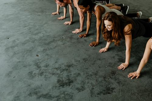 Diverse people practicing a Phalakasana pose - 1201656