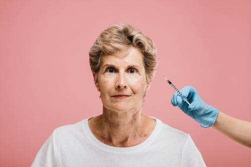 Senior woman getting a botox injection - 1203186