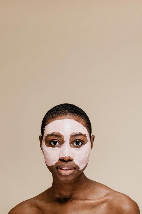 Black woman doing a face mask - 1203308