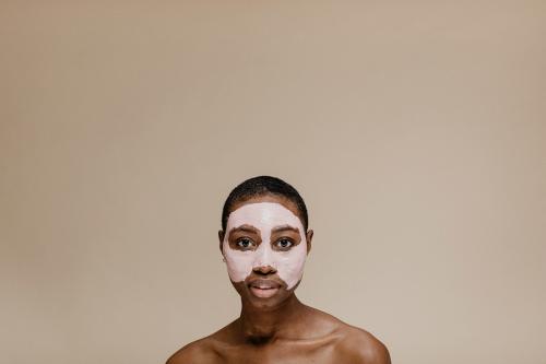 Black woman doing a face mask - 1203396