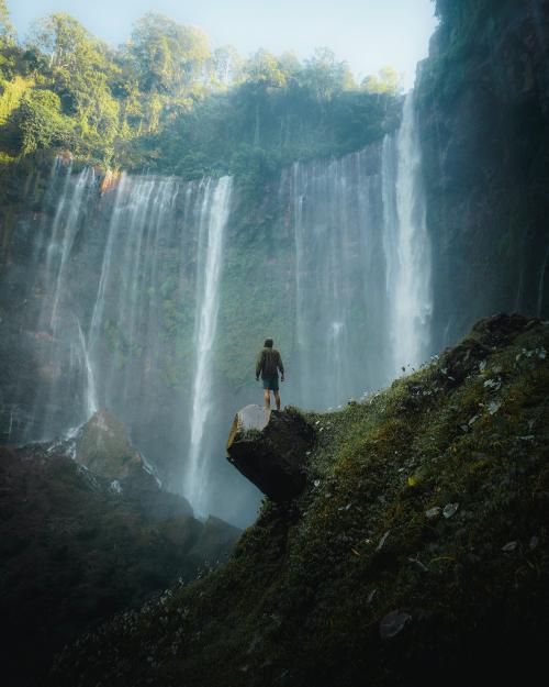 Man standing by Tumpak Sewu Waterfalls, Indonesia - 1204721